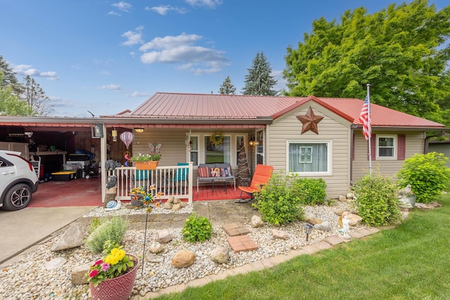 844 Reservoir Rd, Bellefontaine, OH 43311 - ranch-style house featuring covered porch, a metal roof, a carport, and driveway