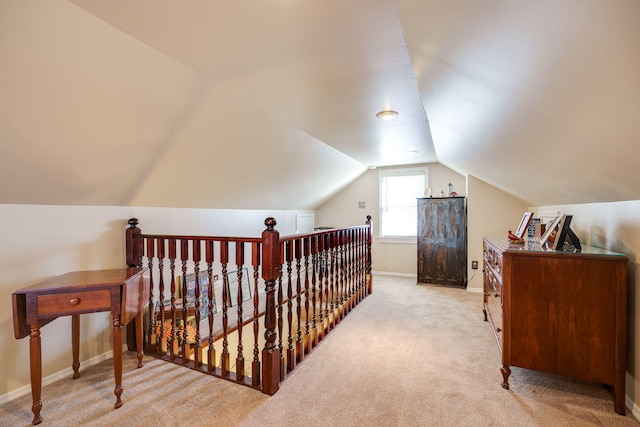 additional living space featuring lofted ceiling and light colored carpet