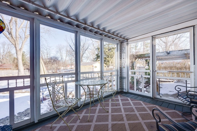 unfurnished sunroom featuring a wealth of natural light