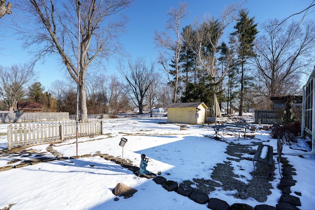 snowy yard with a storage unit