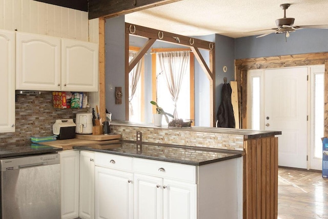 kitchen with white cabinets, decorative backsplash, plenty of natural light, and dishwasher