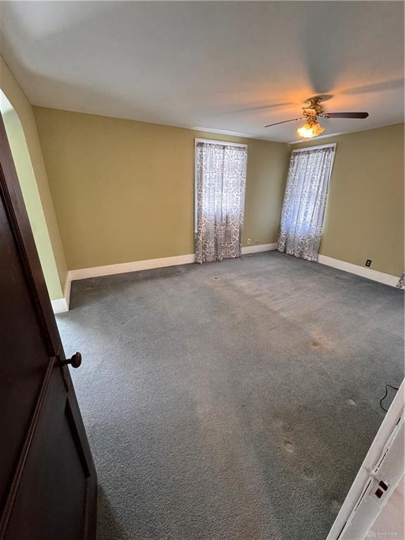 230 New Columbia Blvd, Sidney, OH 45365 - empty room featuring baseboards, carpet, and a ceiling fan