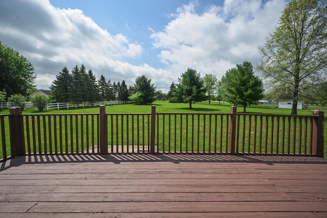 wooden deck featuring a lawn and fence
