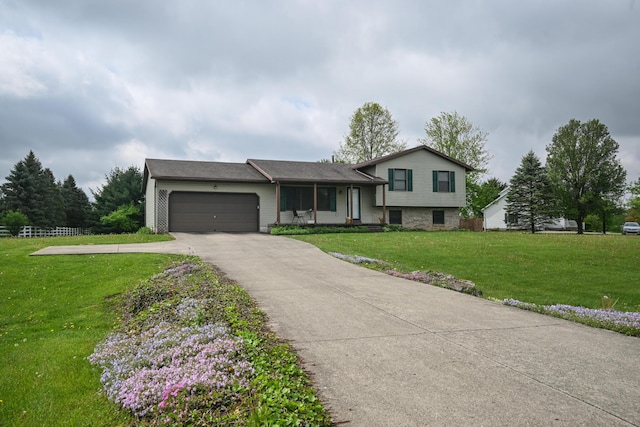 tri-level home with a garage, driveway, and a front yard