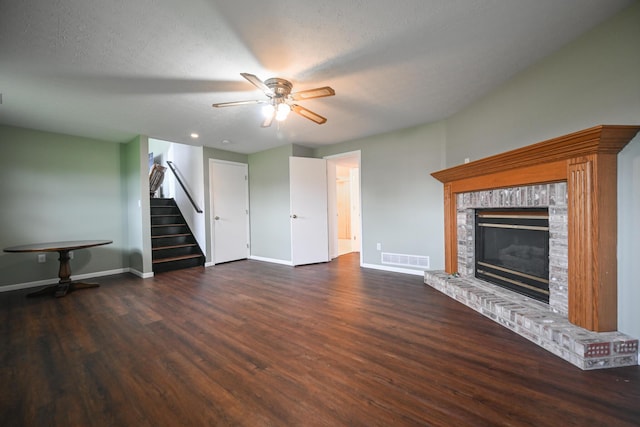 unfurnished living room featuring baseboards, ceiling fan, wood finished floors, and stairway