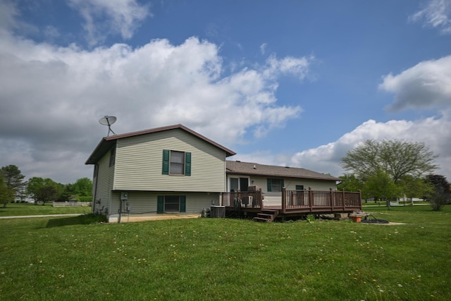 rear view of house featuring a yard, a deck, and cooling unit