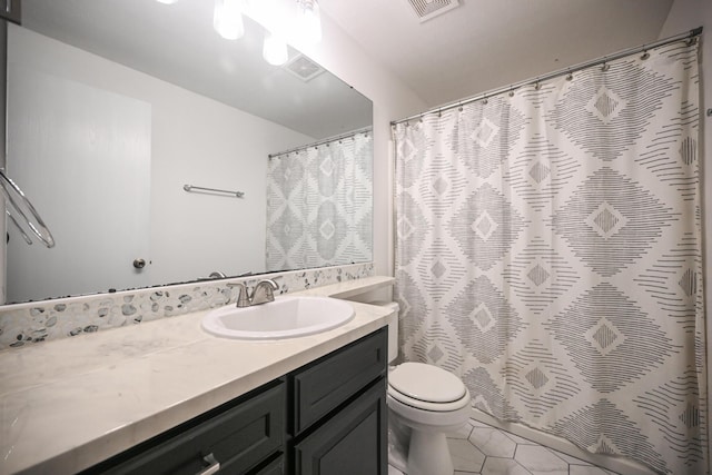 bathroom with visible vents, tile patterned flooring, curtained shower, vanity, and toilet