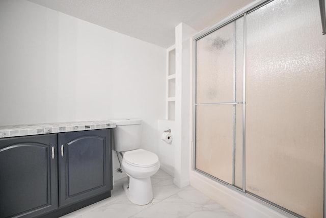 bathroom with toilet, marble finish floor, and a stall shower