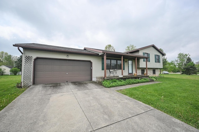 split level home featuring covered porch, an attached garage, concrete driveway, and a front lawn
