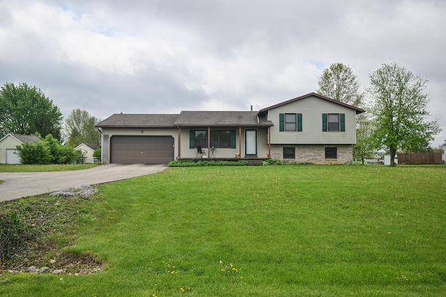 split level home featuring an attached garage, driveway, and a front yard