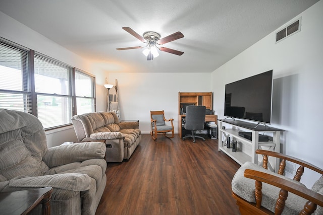 living room featuring visible vents, dark wood finished floors, ceiling fan, and baseboards