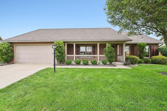 1856 Willow Lakes Dr, Springfield, OH 45502 - view of front facade featuring brick siding, a porch, an attached garage, driveway, and a front yard