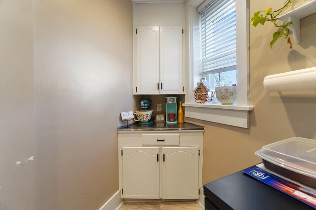 kitchen featuring electric stove, sink, light hardwood / wood-style floors, and white cabinets