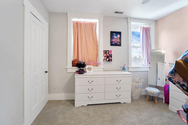 bedroom featuring light colored carpet and ceiling fan