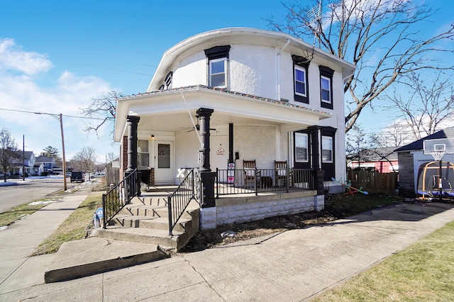 view of front of property with a porch and stucco siding