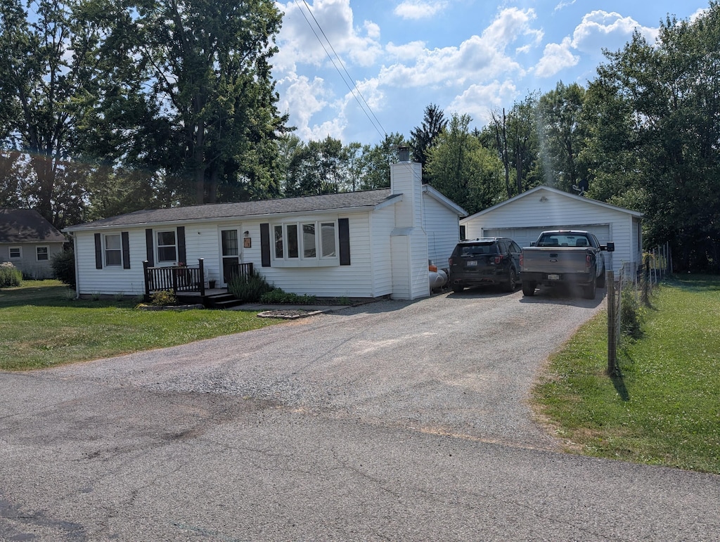 418 High Ave, Russells Point, OH 43348 - ranch-style house with a detached garage, a front yard, a chimney, and an outbuilding