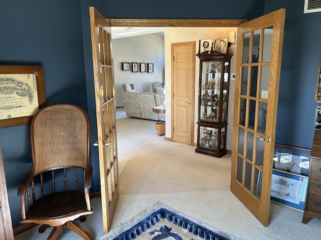 hallway featuring carpet flooring, french doors, and visible vents