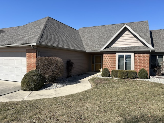single story home featuring a front yard, brick siding, an attached garage, and a shingled roof
