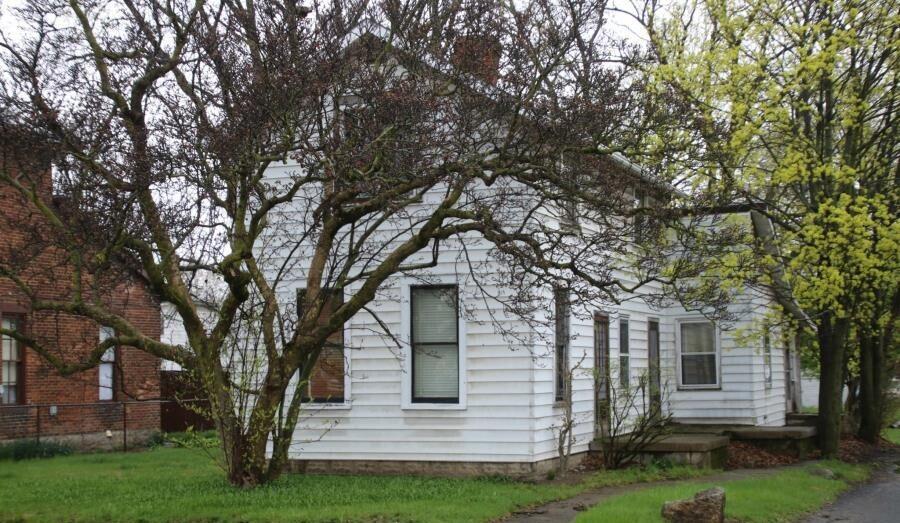 view of side of home featuring a yard