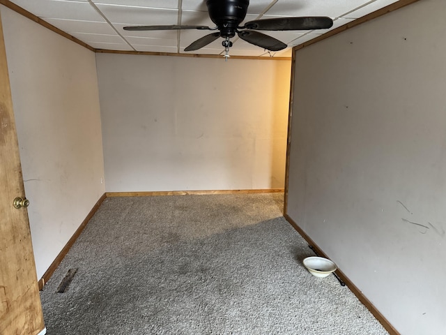 unfurnished room with ceiling fan, carpet, and a drop ceiling