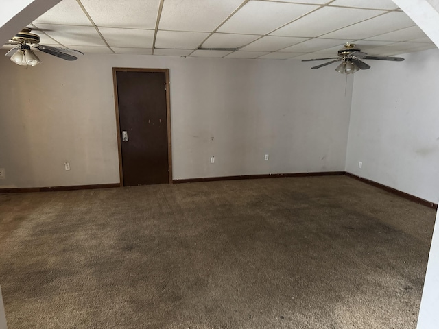 carpeted empty room featuring ceiling fan and a paneled ceiling