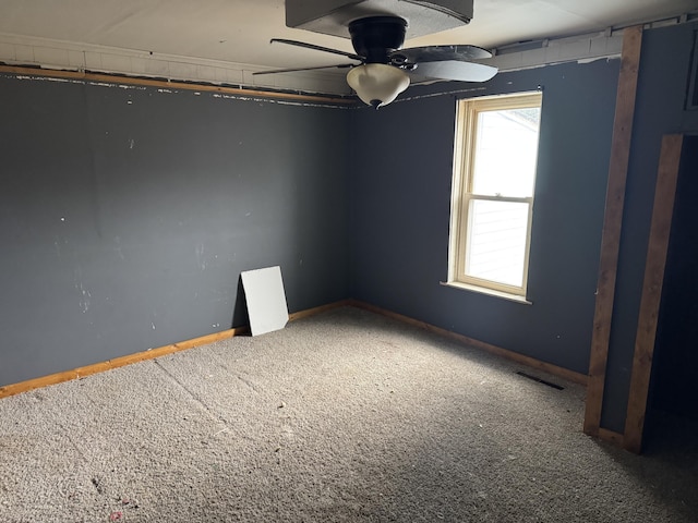 spare room featuring ceiling fan and carpet