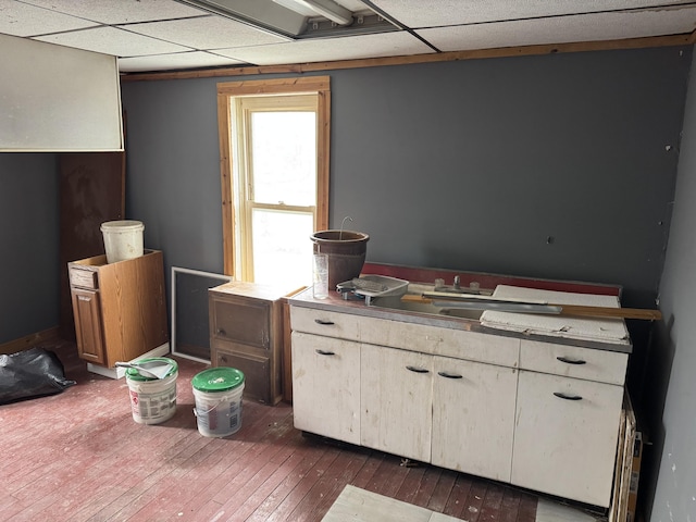 kitchen with white cabinetry, a paneled ceiling, dark hardwood / wood-style floors, and sink