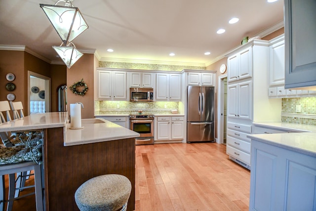 1205 Daylily Way, Troy, OH 45373 - kitchen with stainless steel appliances, ornamental molding, backsplash, pendant lighting, and white cabinets