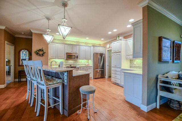 1205 Daylily Way, Troy, OH 45373 - kitchen with stainless steel appliances, a peninsula, a breakfast bar area, decorative backsplash, and crown molding
