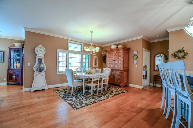 1205 Daylily Way, Troy, OH 45373 - dining area featuring a chandelier, light wood-type flooring, and ornamental molding