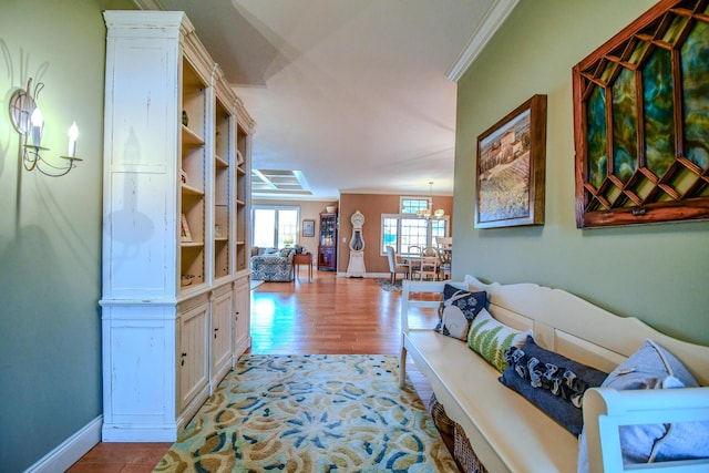 1205 Daylily Way, Troy, OH 45373 - hallway featuring wood finished floors, crown molding, and a chandelier