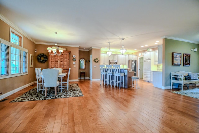 1205 Daylily Way, Troy, OH 45373 - dining space featuring a chandelier, crown molding, light wood finished floors, and recessed lighting