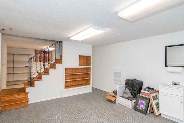 interior space with baseboards, visible vents, stairway, a textured ceiling, and carpet flooring