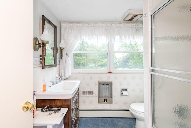 full bathroom featuring toilet, baseboard heating, a wealth of natural light, and vanity