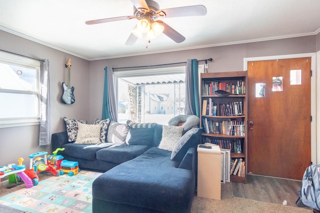 living room with ornamental molding, wood finished floors, and a ceiling fan