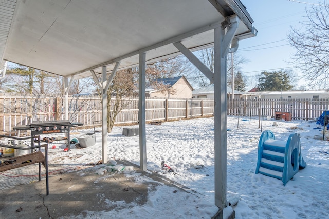 yard layered in snow featuring a fenced backyard