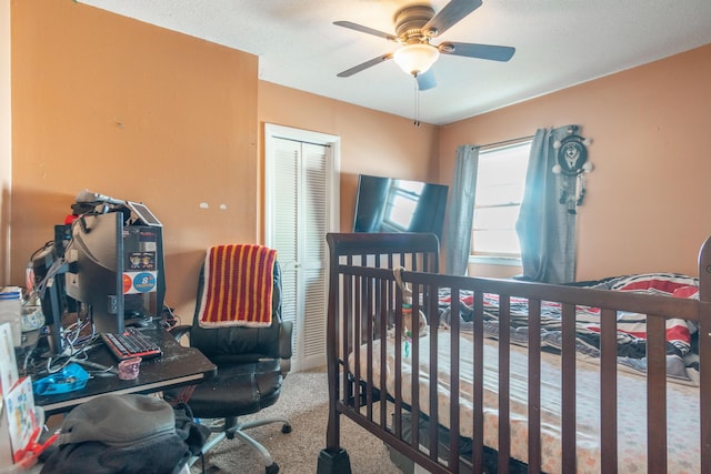 bedroom featuring ceiling fan, a closet, and carpet flooring