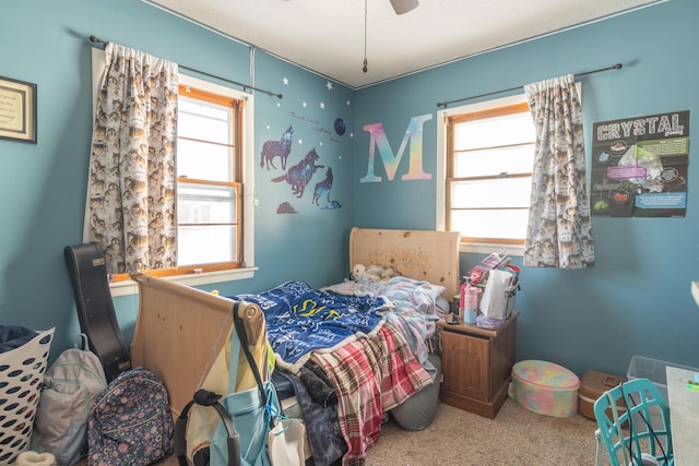 bedroom with multiple windows, carpet flooring, and a ceiling fan