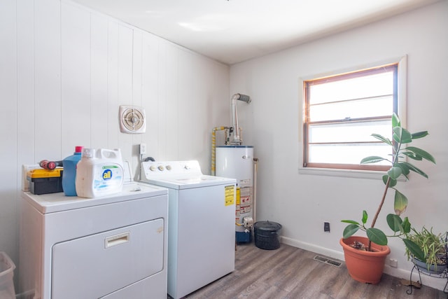 laundry area featuring gas water heater, laundry area, wood finished floors, visible vents, and washer and clothes dryer