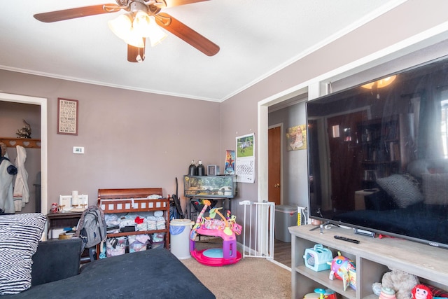 carpeted bedroom with ceiling fan and ornamental molding