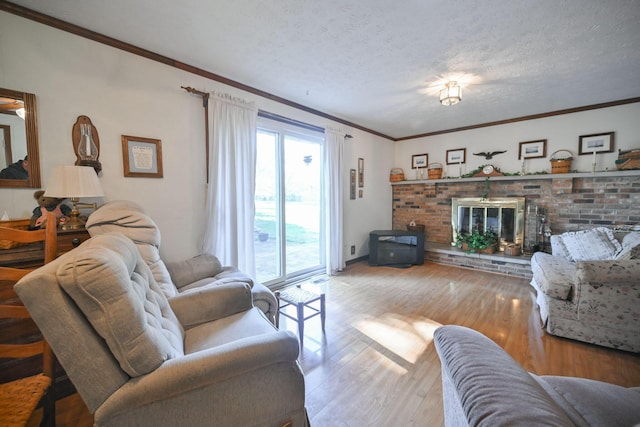 5283 Willow Dale Rd, Urbana, OH 43078 - living area with a fireplace, wood finished floors, a textured ceiling, and crown molding