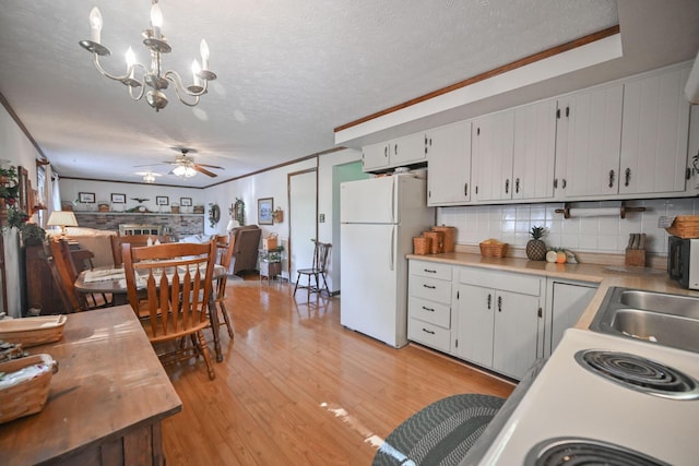 5283 Willow Dale Rd, Urbana, OH 43078 - kitchen with light countertops, a sink, freestanding refrigerator, light wood-type flooring, and a textured ceiling