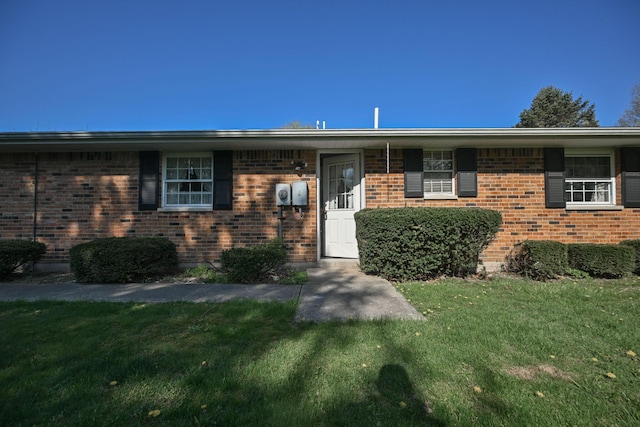 5283 Willow Dale Rd, Urbana, OH 43078 - property entrance with a lawn and brick siding