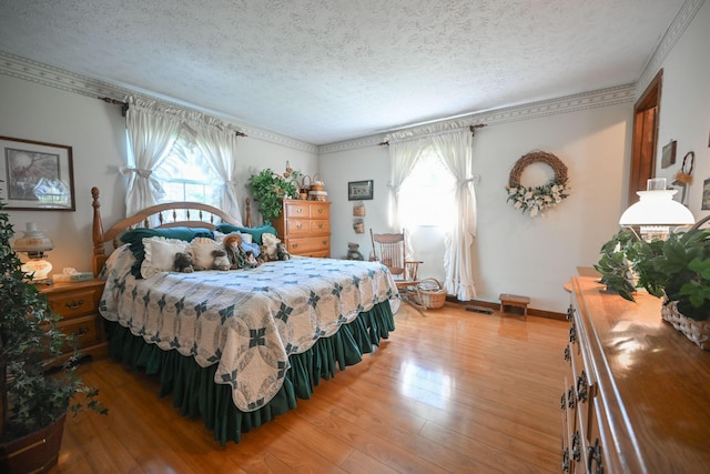 5283 Willow Dale Rd, Urbana, OH 43078 - bedroom with light wood-style flooring, a textured ceiling, and multiple windows