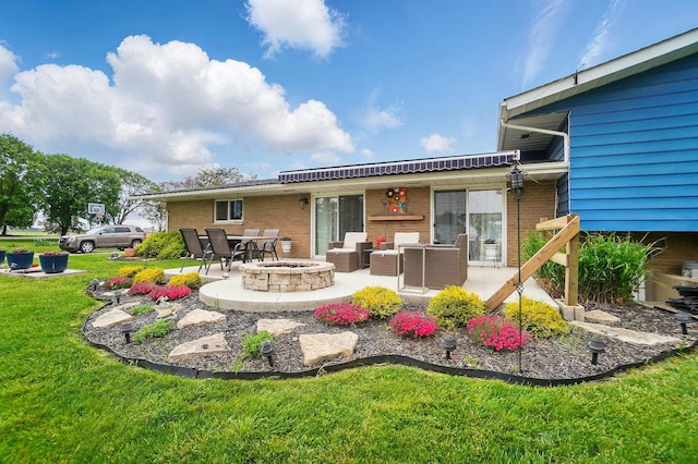 2206 State Route 56, London, OH 43140 - back of house featuring a patio, a yard, brick siding, and an outdoor living space with a fire pit
