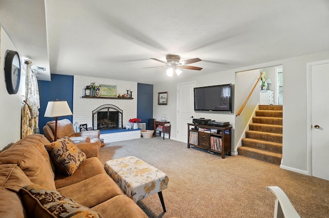 2206 State Route 56, London, OH 43140 - carpeted living area with ceiling fan, a fireplace, and stairway