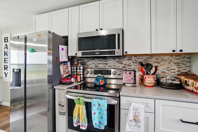 2206 State Route 56, London, OH 43140 - kitchen featuring stainless steel appliances, white cabinets, and tasteful backsplash