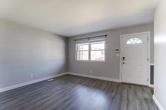 entrance foyer featuring dark wood finished floors, visible vents, and baseboards