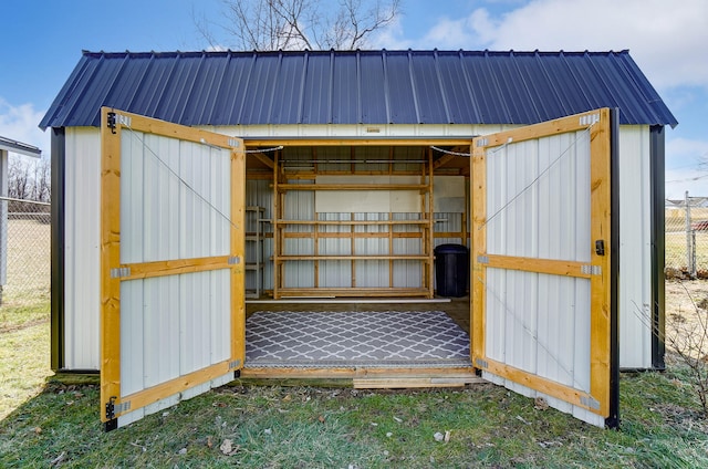 view of outdoor structure featuring an outbuilding and fence