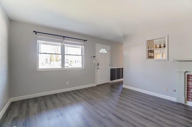 foyer with baseboards and dark wood-style floors